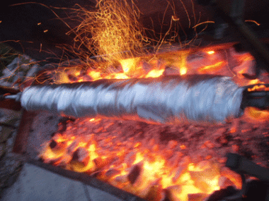 In Folie gewickeltes Fleisch wird nach traditioneller kretischer Art über glühenden Kohlen und offenem Feuer bei Zorbas Island gegart.